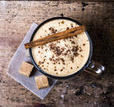 frothy-cup-of-espresso-coffee-with-cinnamon-topped-with-sprinkled-chocolate-on-old-wooden-background_142922332